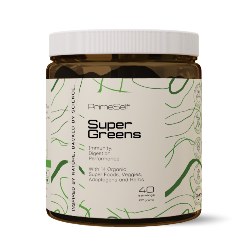 A container of PrimeSelf Organic Super Greens powder with a label showing the product name and mentions of key ingredients such as wheatgrass, spirulina, and chlorella.