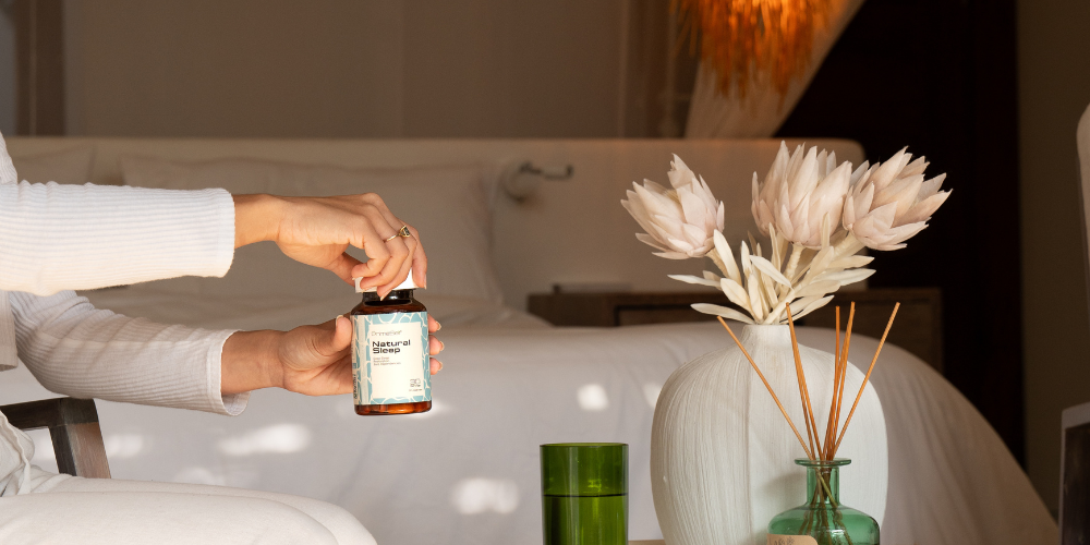 Woman relaxing with a warm drink before bed in a softly lit room